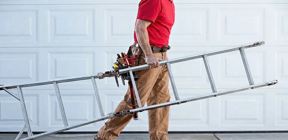 Garage door repair technician arriving with tools and ladder in Huntsville, AL